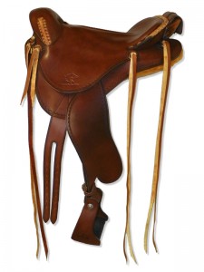 Brown Endurance Saddle with cutback skirts and bulkless English rigging, round pommel, slick seat with Mexican braided cantle, cavalry pouch, streamlined fenders and border tooling.